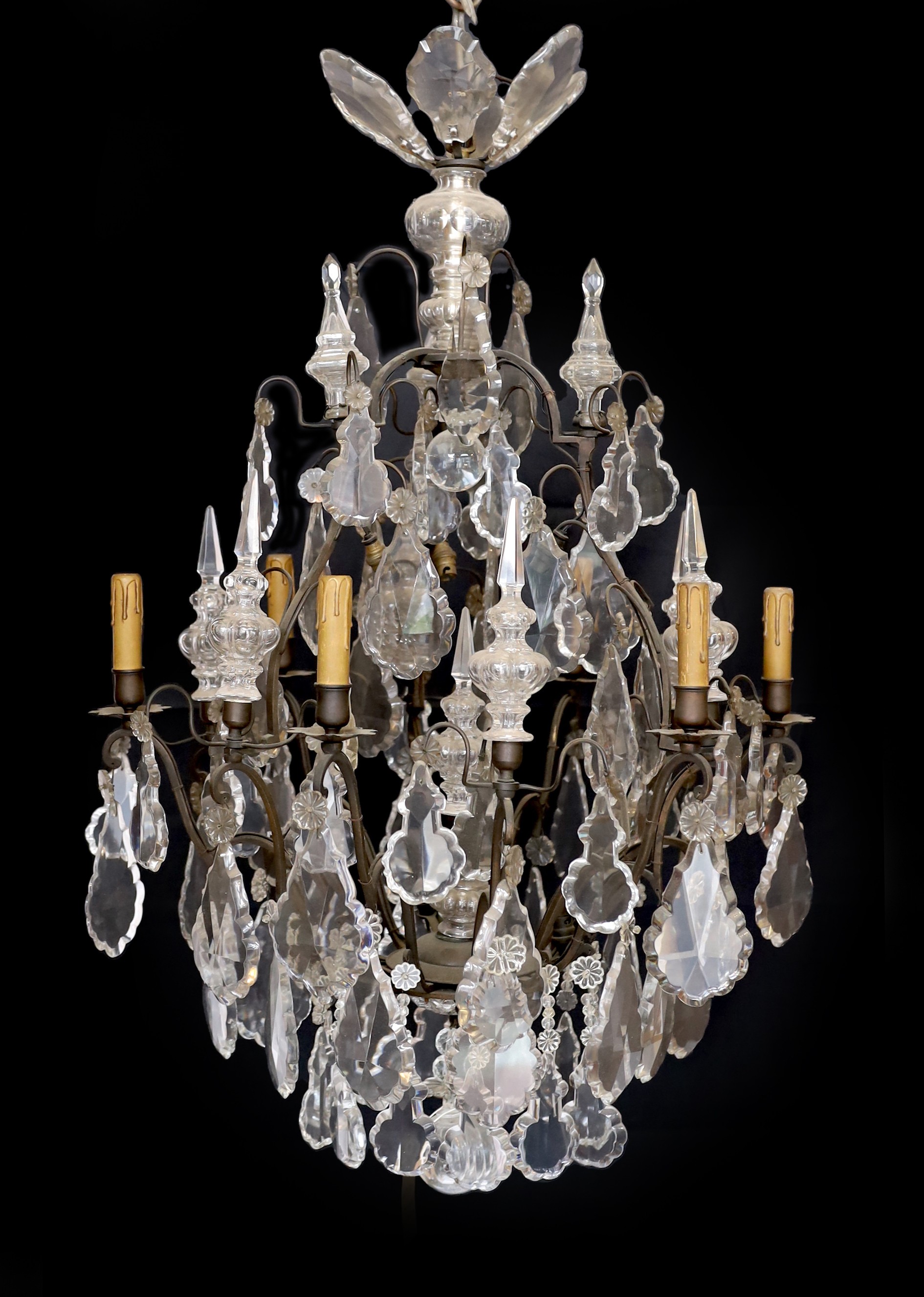 An early 20th century French bronze and cut glass six light chandelier, of particularly ornate design with spear finials, lozenge shaped drops and flower head motifs, height 101cm. width 60cm